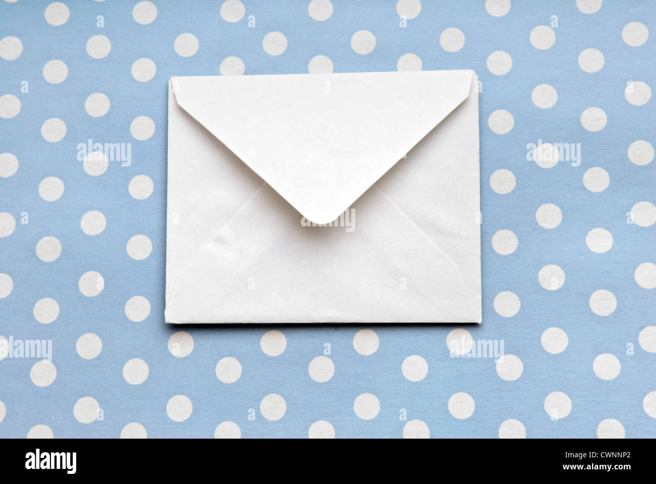 Envelope on gift wrapping paper with polka dots Stock Photo