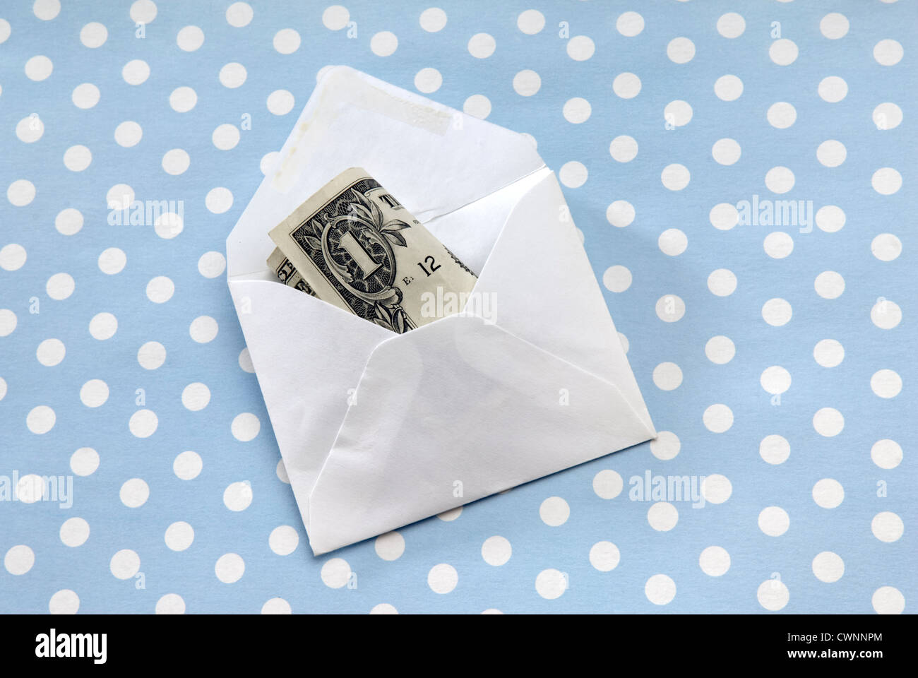 Envelope with a one-dollar bill, money gift on gift wrapping paper Stock Photo