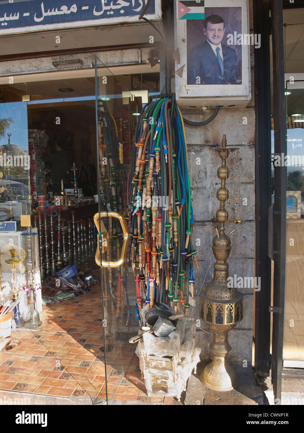 Waterpipe or narghile is in frequent use in Aqaba Jordan. Her a shop displaying mouthpieces and the kings portrait Stock Photo