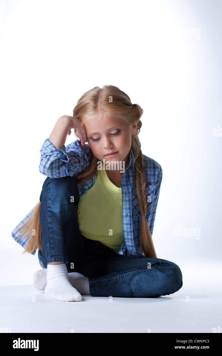 Studio portrait of beautiful blonde girl sit on floor Stock Photo - Alamy