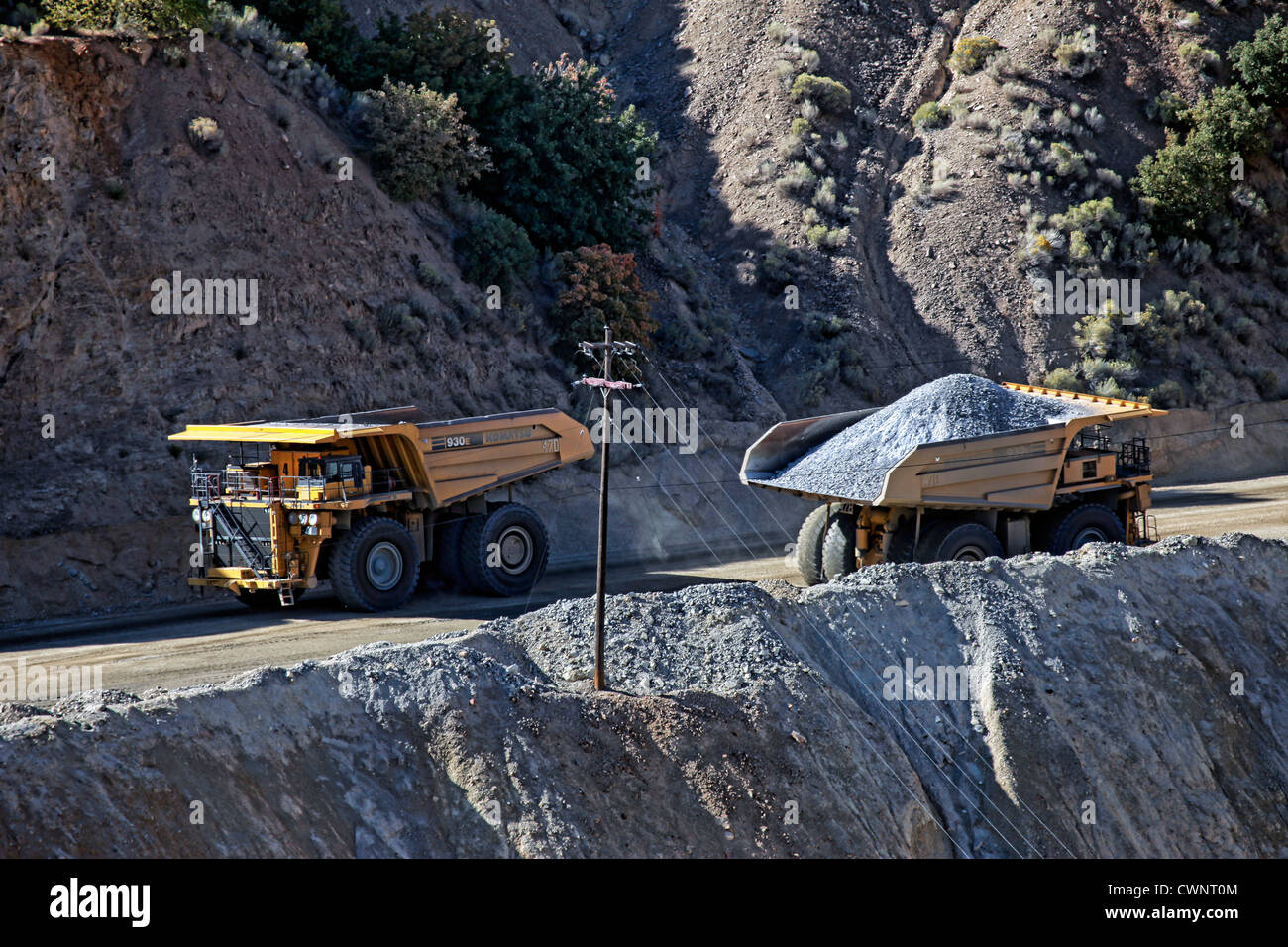 Large mine dump trucks in Kennecott Copper Mine in central Utah. Open pit in foreground. Worlds