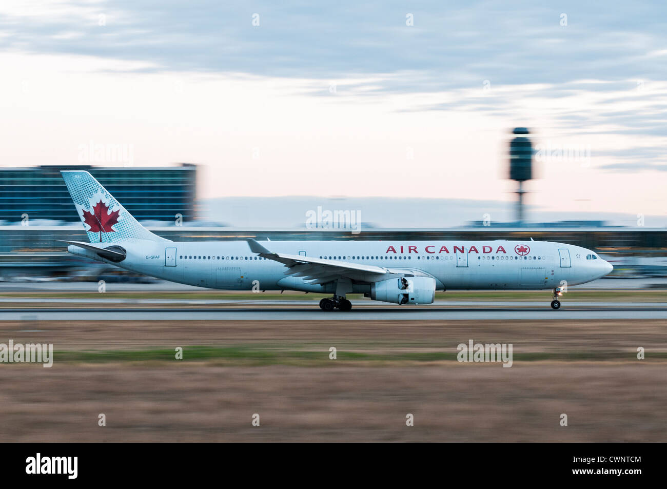 An Air Canada jetliner deploys its engine thrust reversers to slow down after landing at Vancouver International Airport. Stock Photo