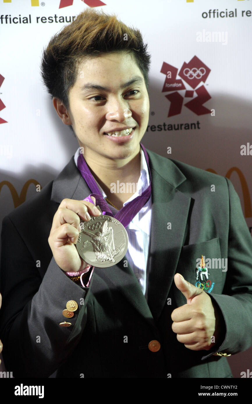 Thai woman weightlifter, Pimsiri Sirikaew shows her silver medal during a ceremony for the athletes' return from the London 2012 Stock Photo
