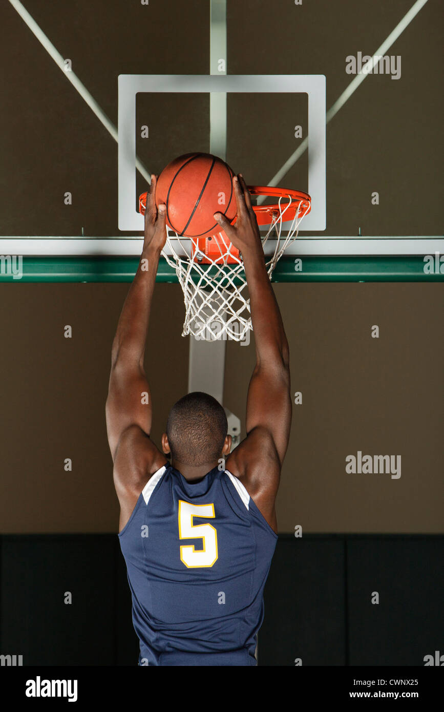 Basketball player making a basket, rear view Stock Photo Alamy