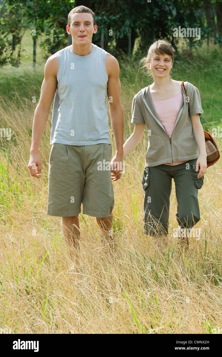 Young couple going for hike, holding hands Stock Photo