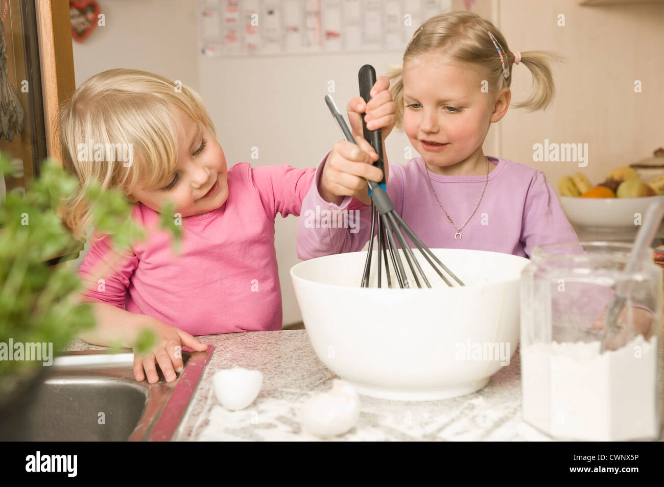Girl mixing batter, smiling Stock Photo - Alamy