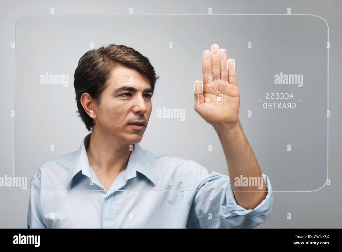 Man gaining access on touch screen interface using biometrics system Stock Photo