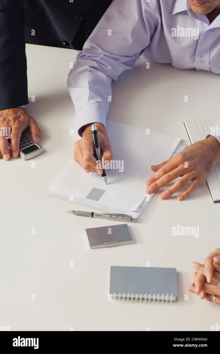 Business associates brainstorming together, cropped Stock Photo