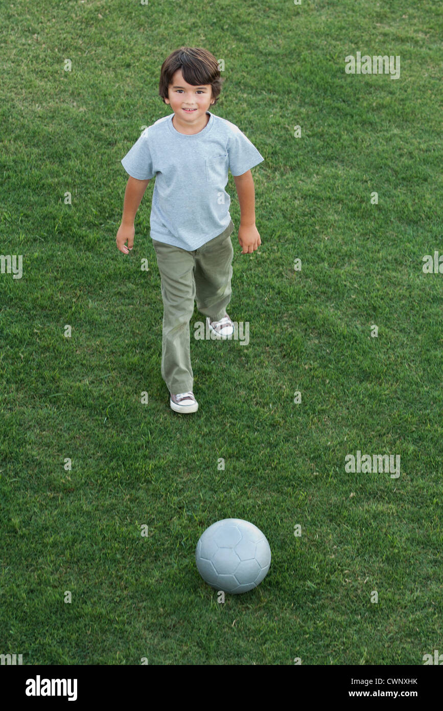 Boy playing with ball outdoors Stock Photo - Alamy