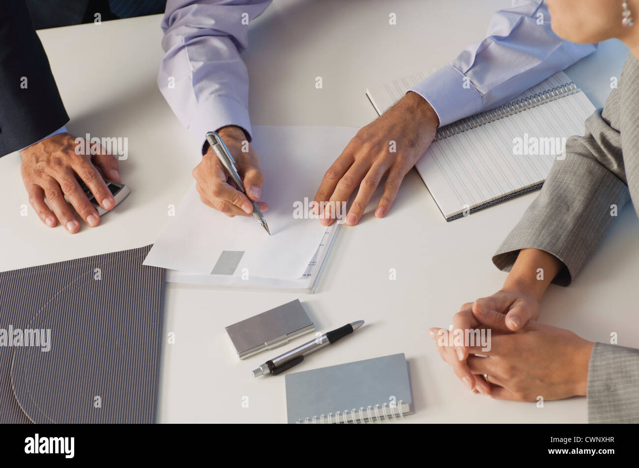 Business associates brainstorming together, cropped Stock Photo