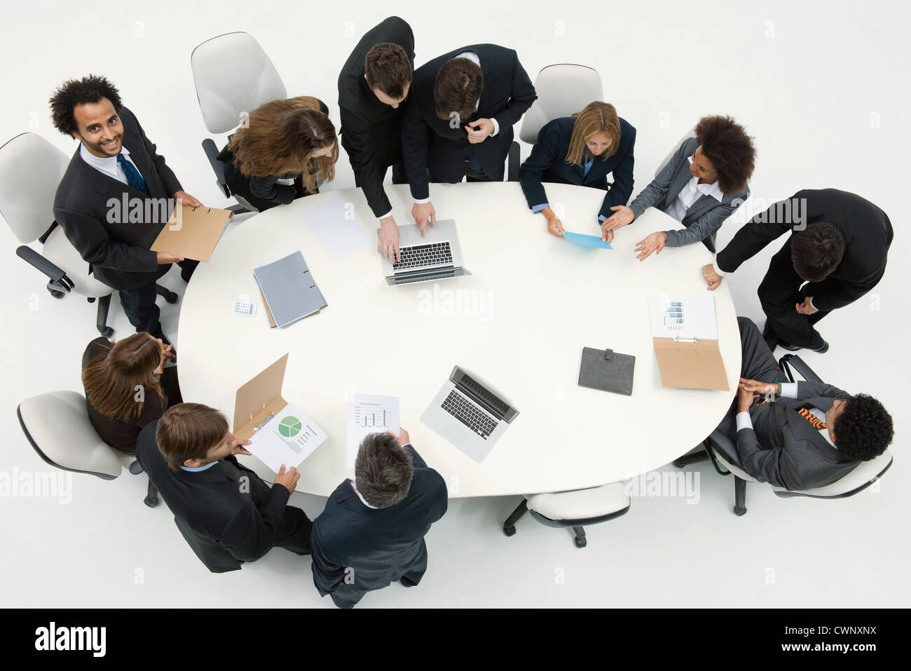 Businessman working with associates at meeting Stock Photo