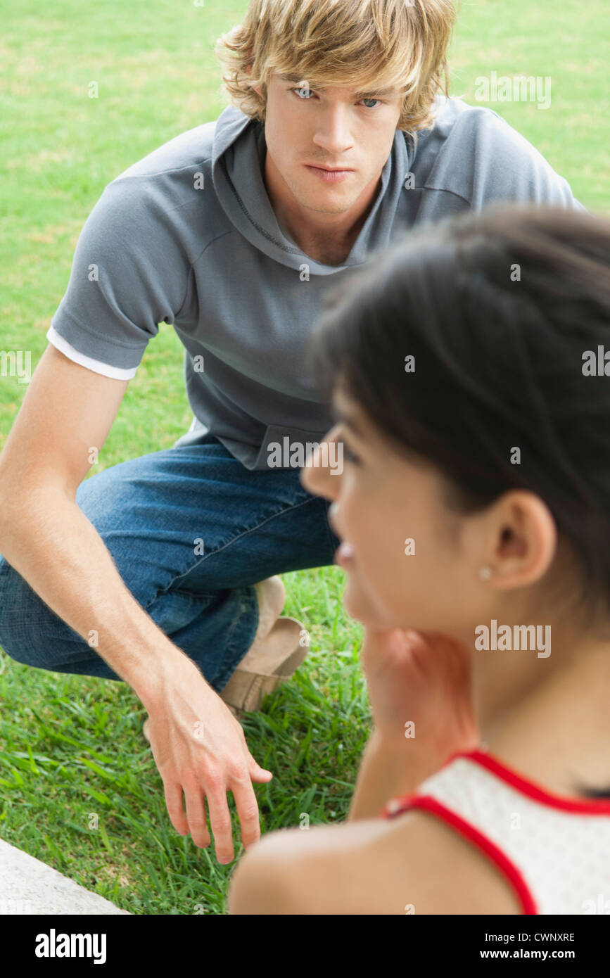 Young man hanging out outdoors with female friend Stock Photo
