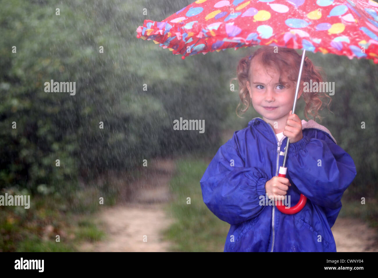 Young girl with an umbrella on a rainy day Stock Photo Alamy