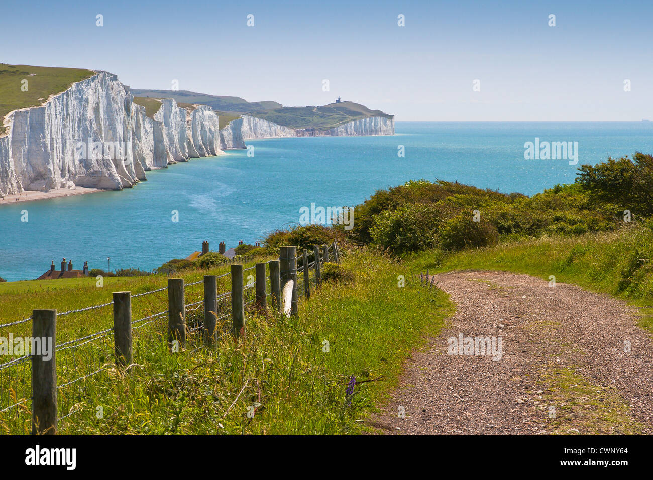 View down the path to the coastguard cottages, along the Seven Sisters to Birling Gap, Belle Tout Lighthouse and Beachy Head. Stock Photo