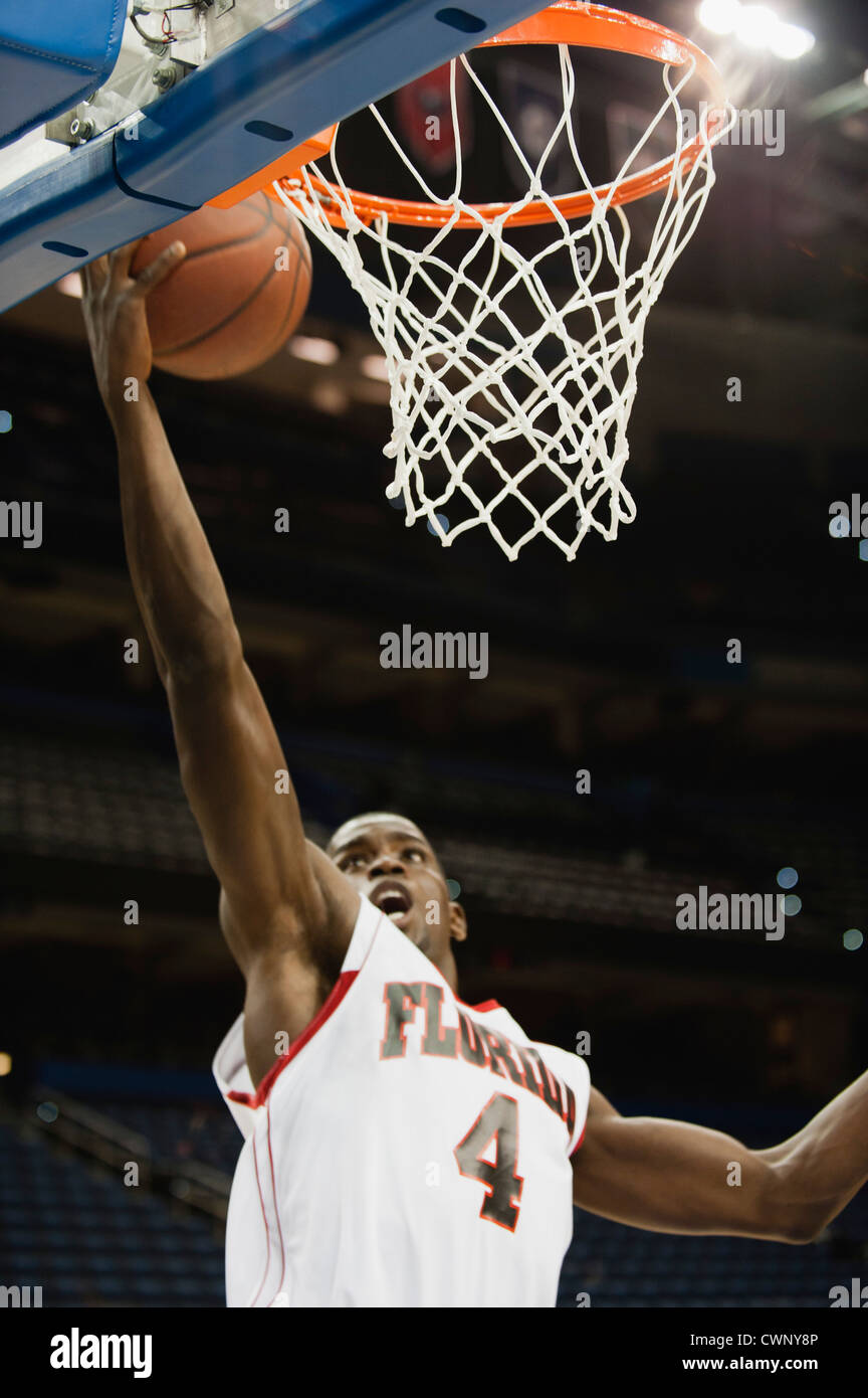 Basketball player making a basket Stock Photo - Alamy