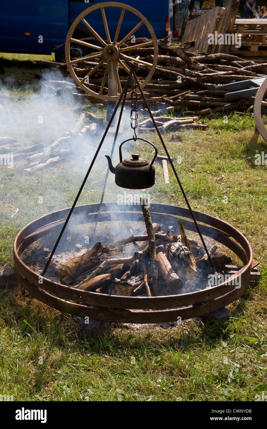 Iron wheelrims being heated on a fire to expand them for fitting to a