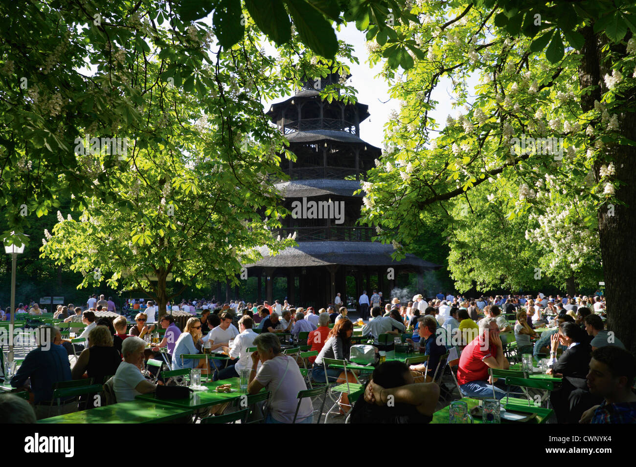 Germany, Bavaria, Munich, English Garden,  Chinese Tower, People sitting at Beer garden Stock Photo