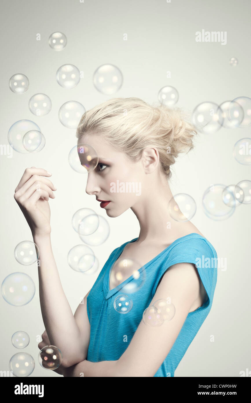 Young woman surrounded by bubbles, portrait Stock Photo