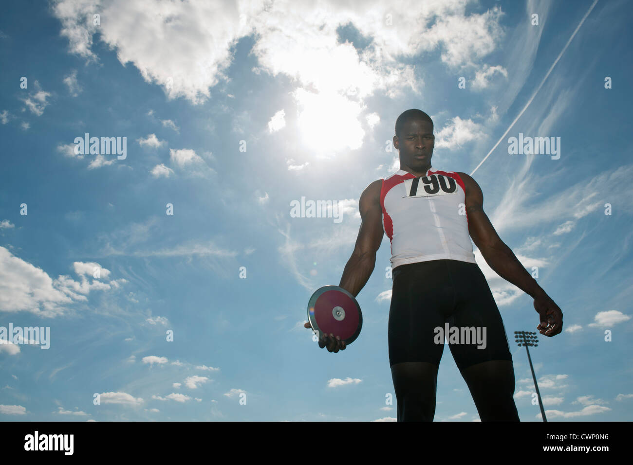 Male athlete holding discus, low angle view Stock Photo
