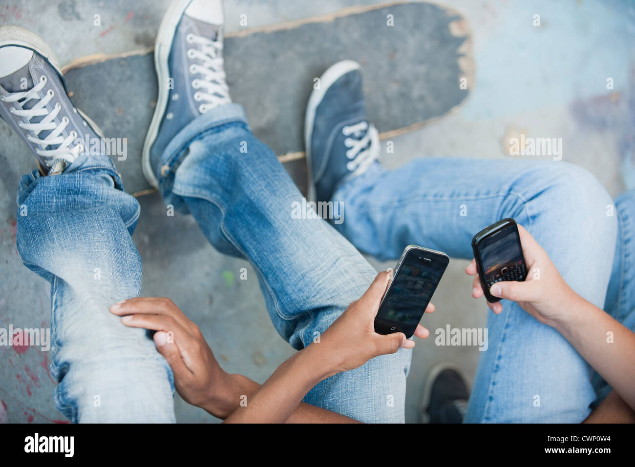 Young men using cell phones, cropped Stock Photo