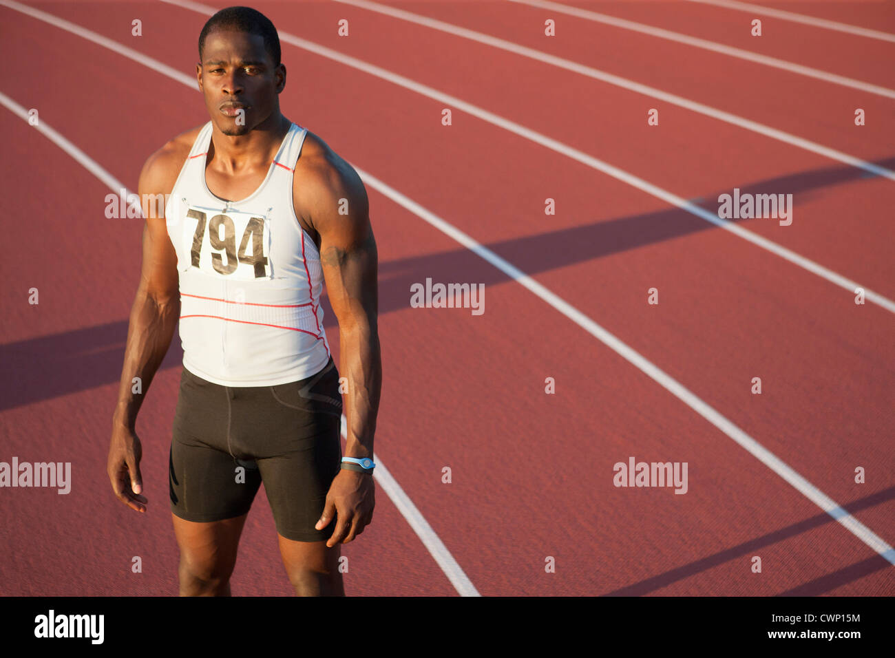 Young athlete standing on running track, portrait Stock Photo