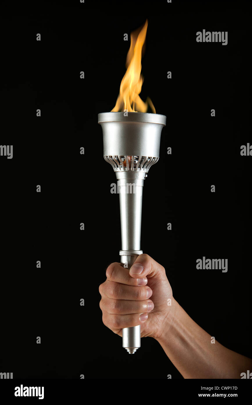 Man's hand holding torch with no flame, cropped Stock Photo