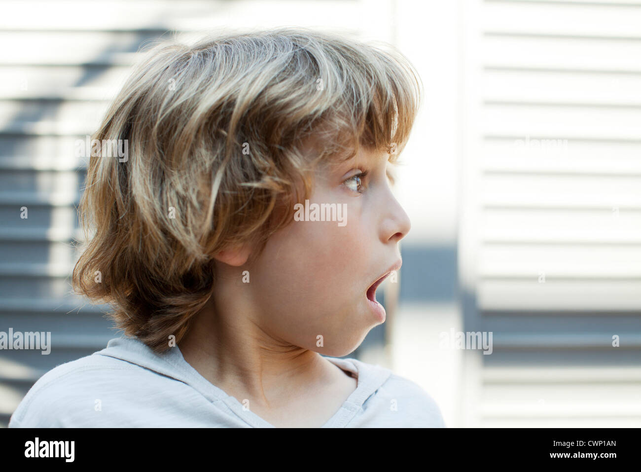 Boy looking away with shocked expression Stock Photo