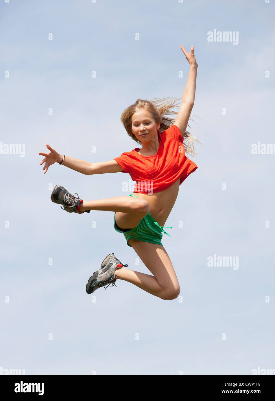 Austria, Teenage girl jumping against sky Stock Photo - Alamy