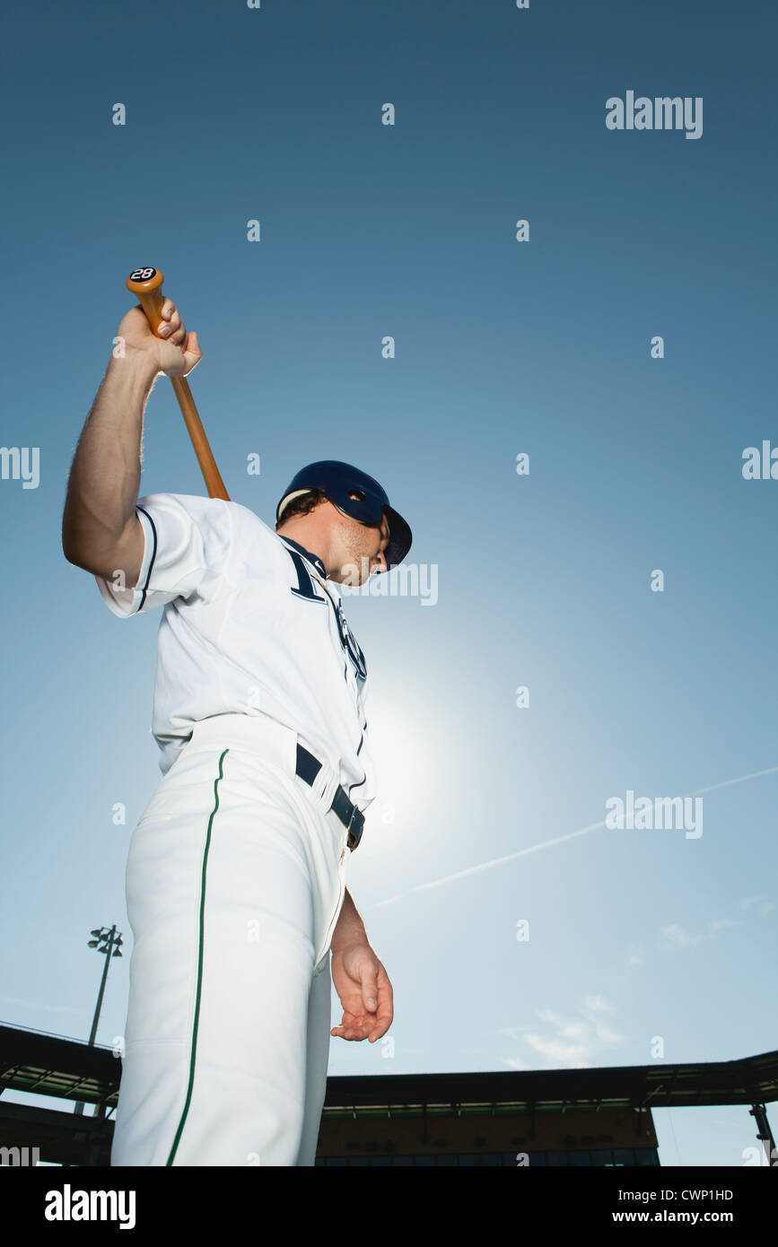 Baseball player holding baseball bat across shoulders Stock Photo