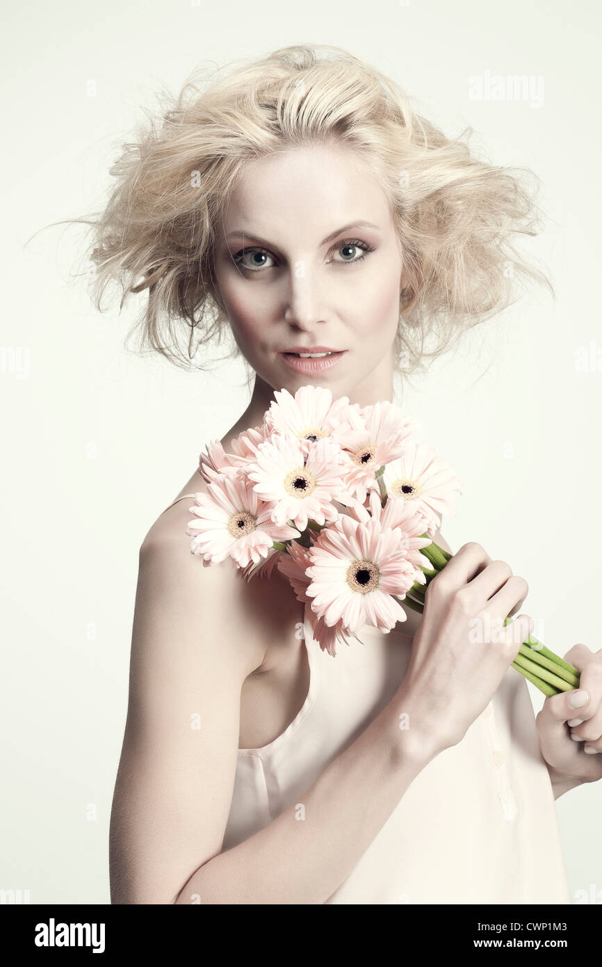 Young woman holding bunch of gerbera daisies, portrait Stock Photo