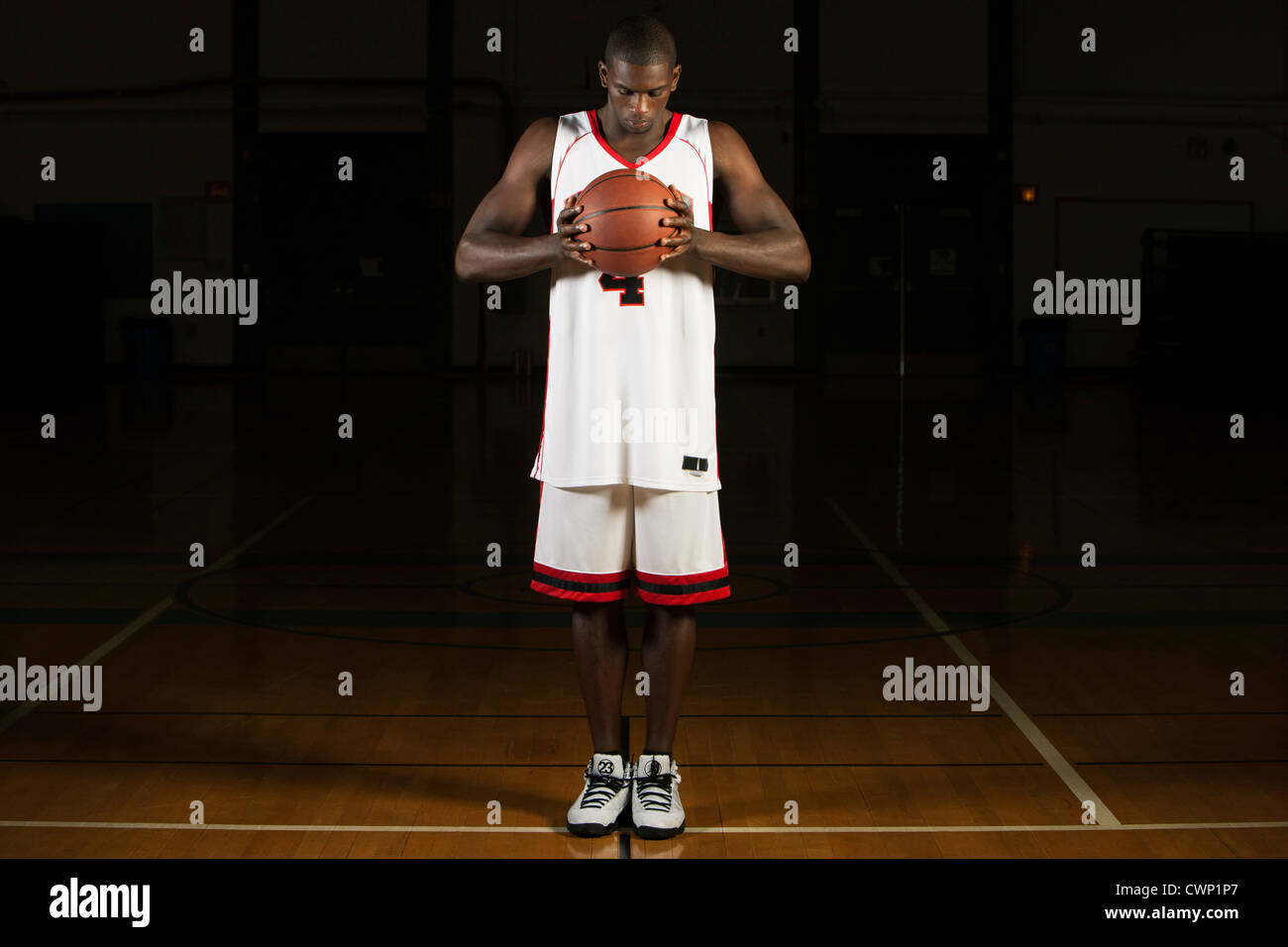 Basketball player holding basketball, portrait Stock Photo