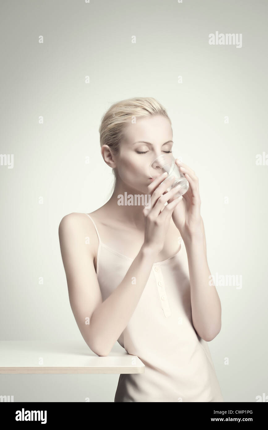 Young woman drinking water from glass, portrait Stock Photo