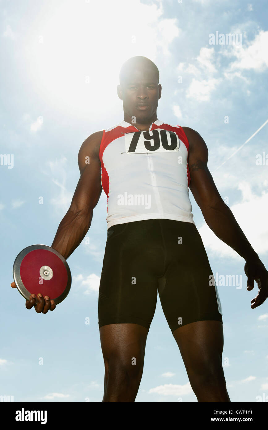 Male athlete holding discus, low angle view Stock Photo