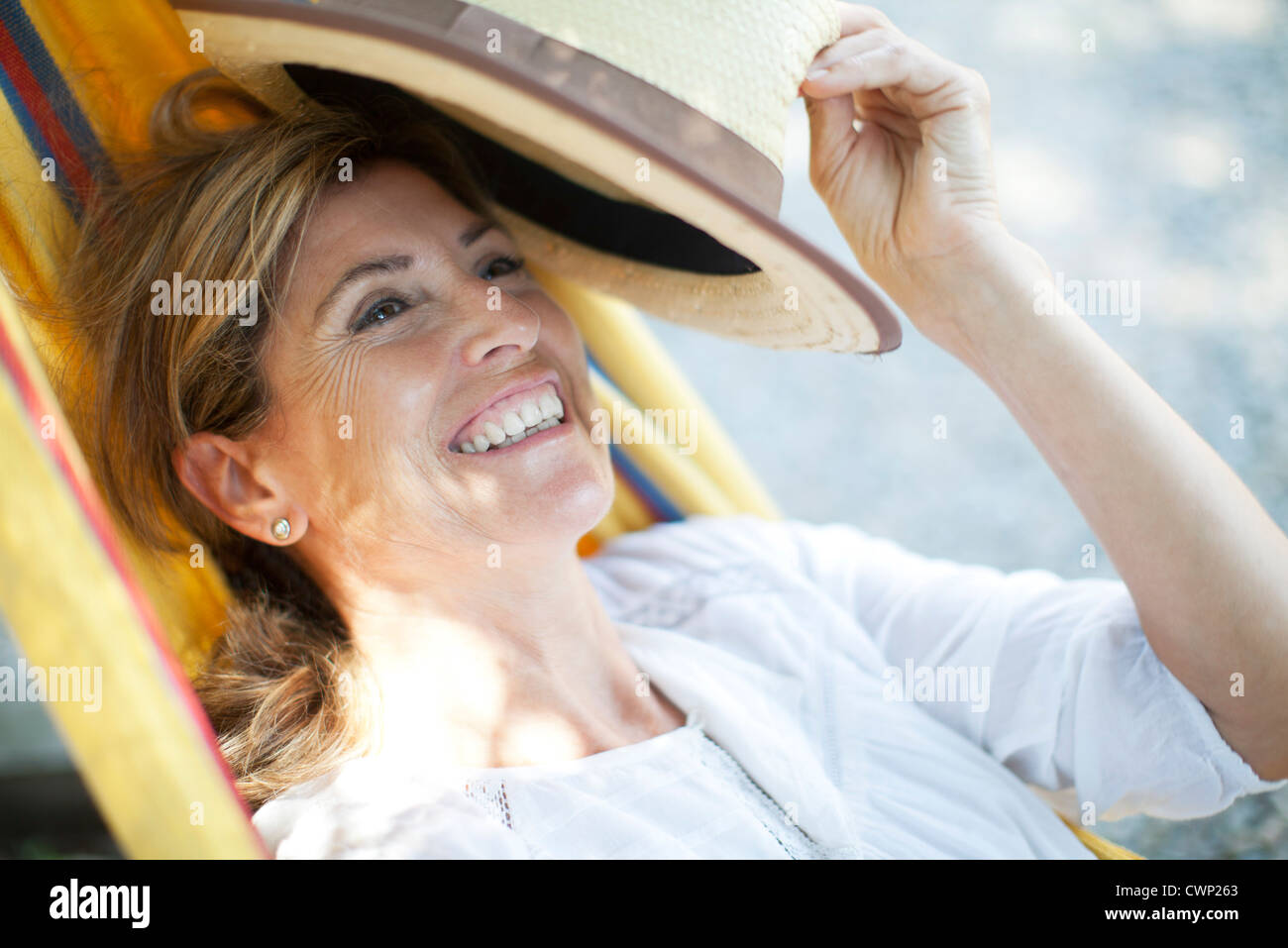 Mature woman relaxing in hammock, portrait Stock Photo - Alamy