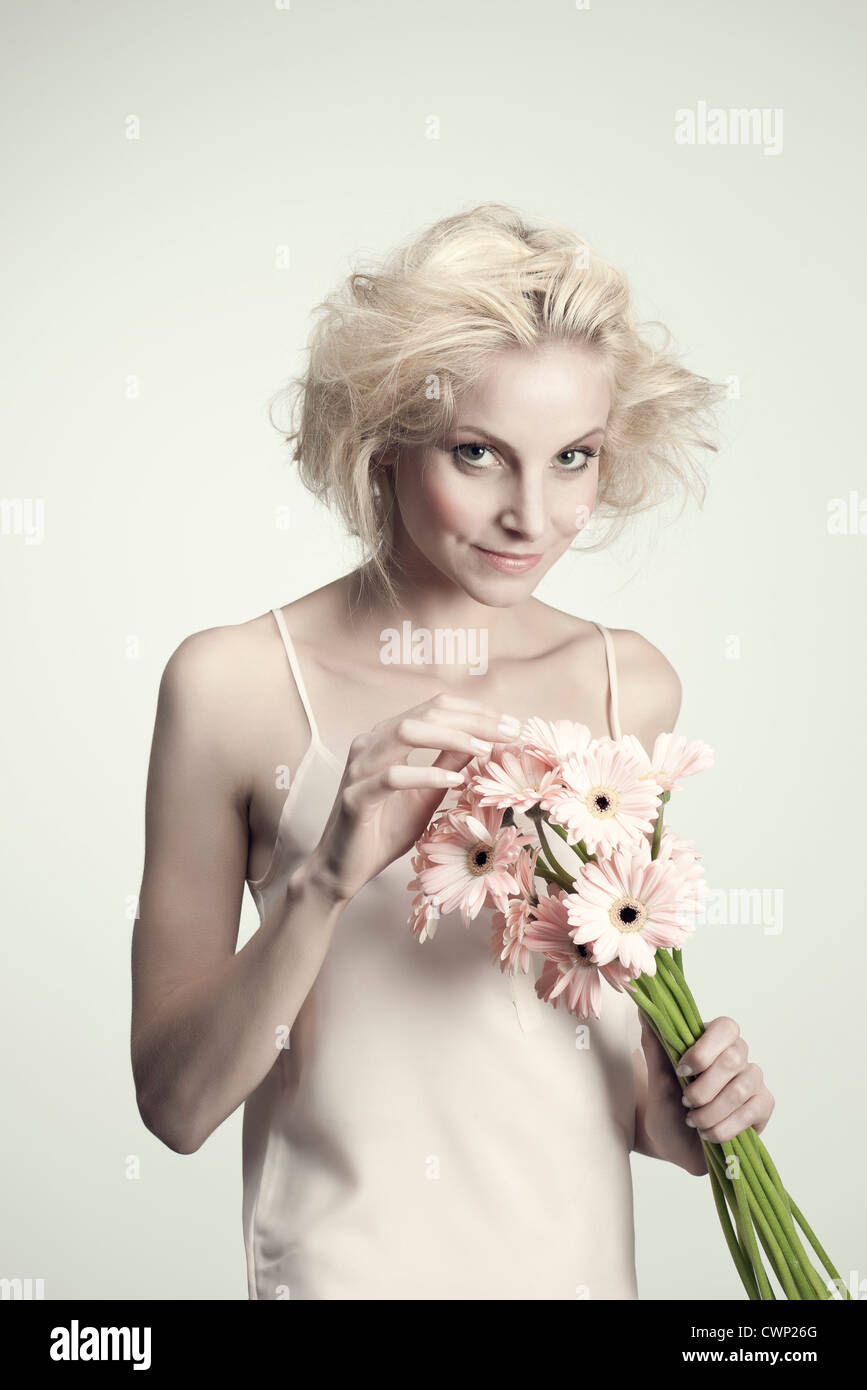 Young woman holding bunch of gerbera daisies Stock Photo - Alamy