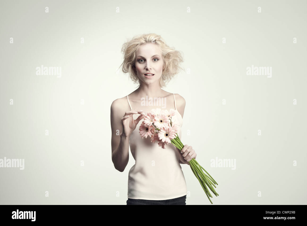 Young woman holding bunch of gerbera daisies Stock Photo - Alamy