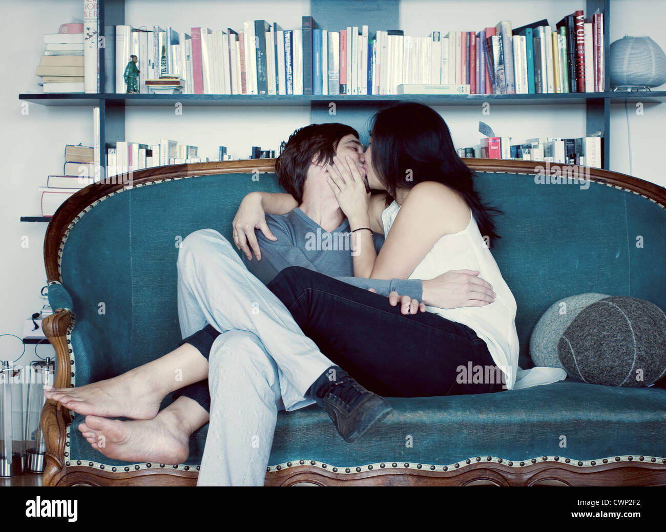 Couple kissing on sofa Stock Photo - Alamy