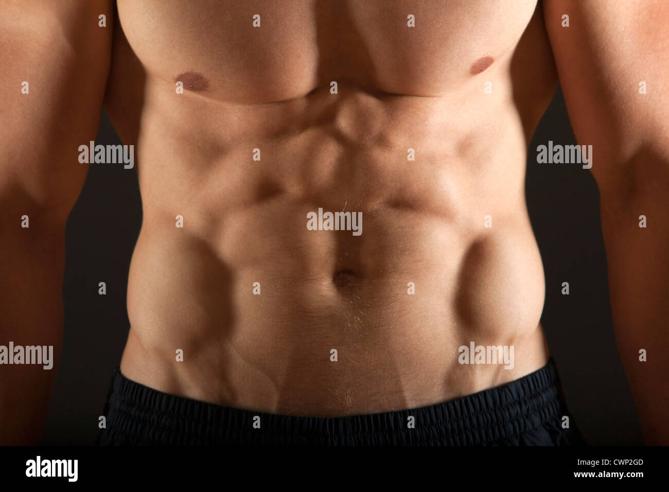 Barechested body builder's abdomen, close-up Stock Photo