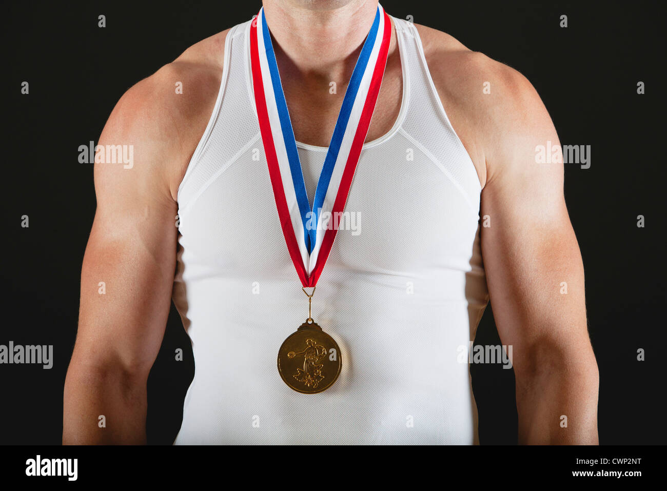Male gymnast with gold medal, mid section Stock Photo