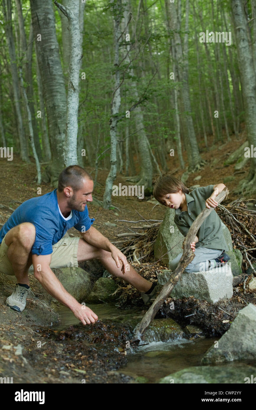 Father and son playing in woods Stock Photo