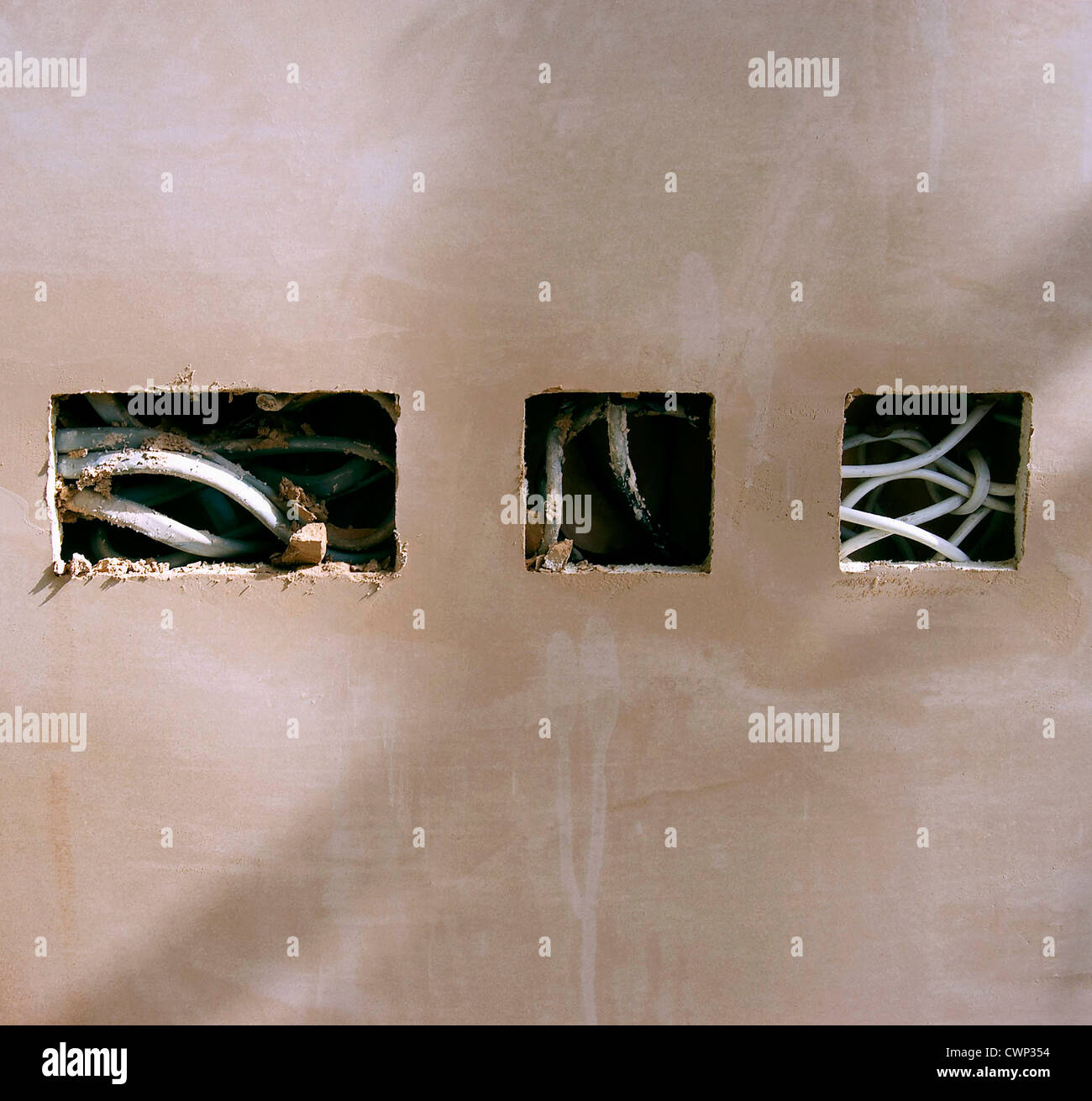 Electrical wires hanging out on a new plastered wall Stock Photo Alamy