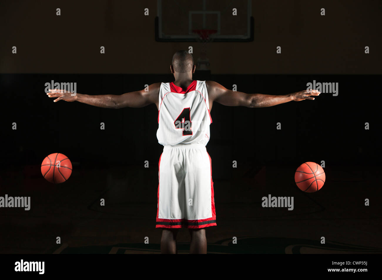 Basketball player dribbling two balls Stock Photo