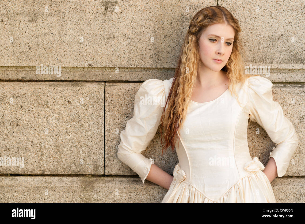 a young attractive woman with long blonde hair in an Alt alternative bride  fashion shoot, on location UK looking sad Stock Photo - Alamy