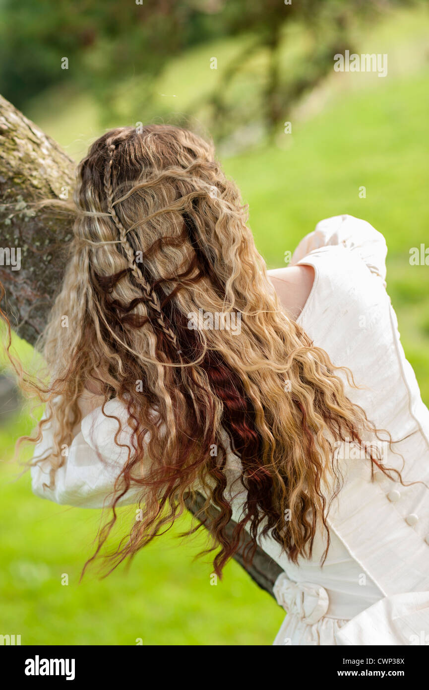 Back rear view of a young attractive woman with long blonde hair in an Alt  alternative bride fashion shoot, on location UK Stock Photo - Alamy