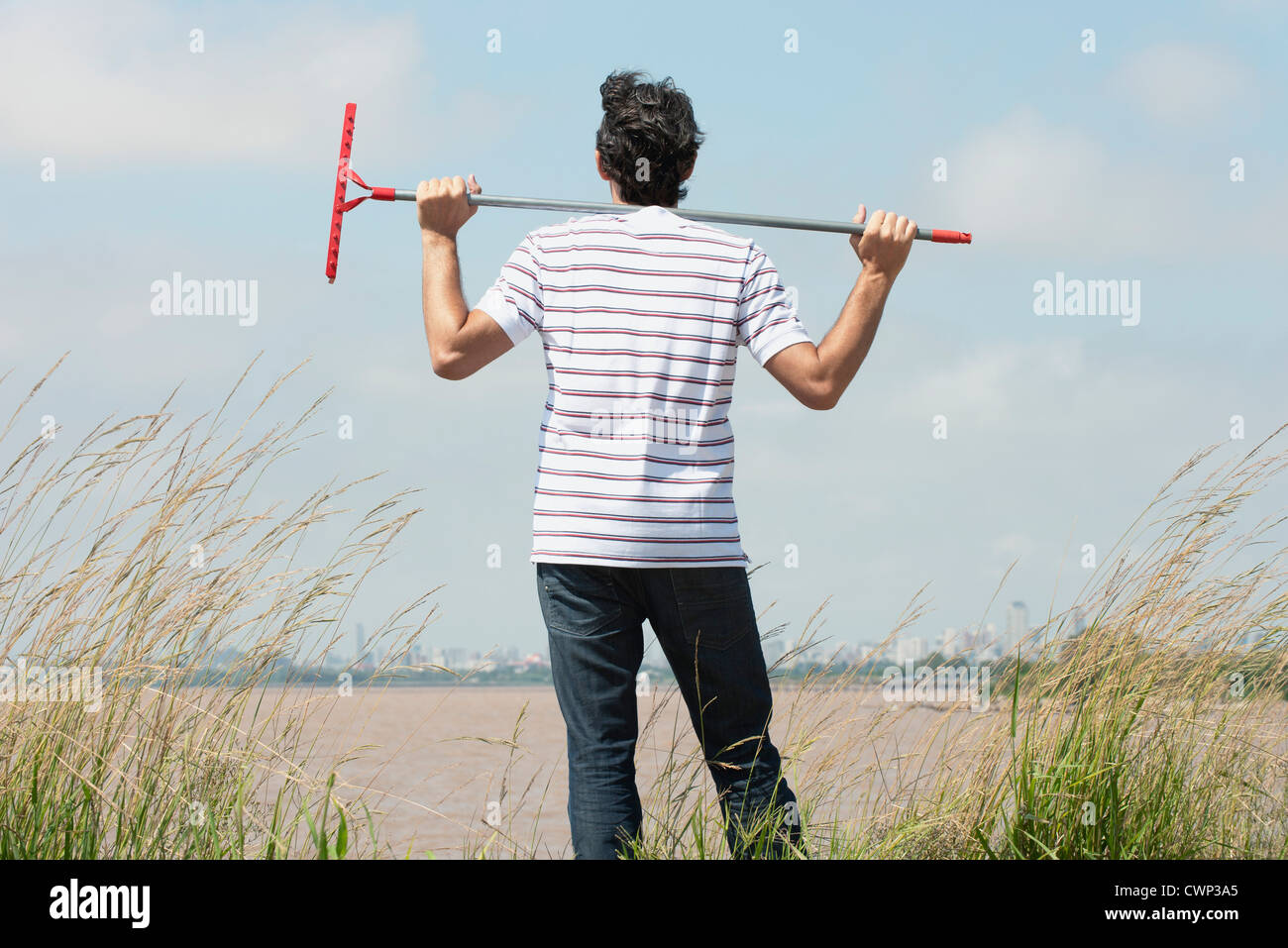 Mature man holding rake on hires stock photography and images Alamy