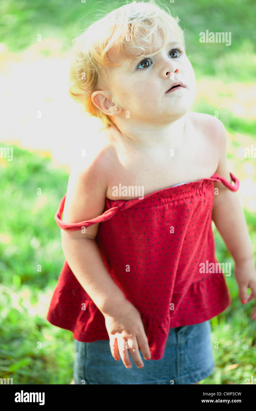 Baby girl looking up, portrait Stock Photo - Alamy