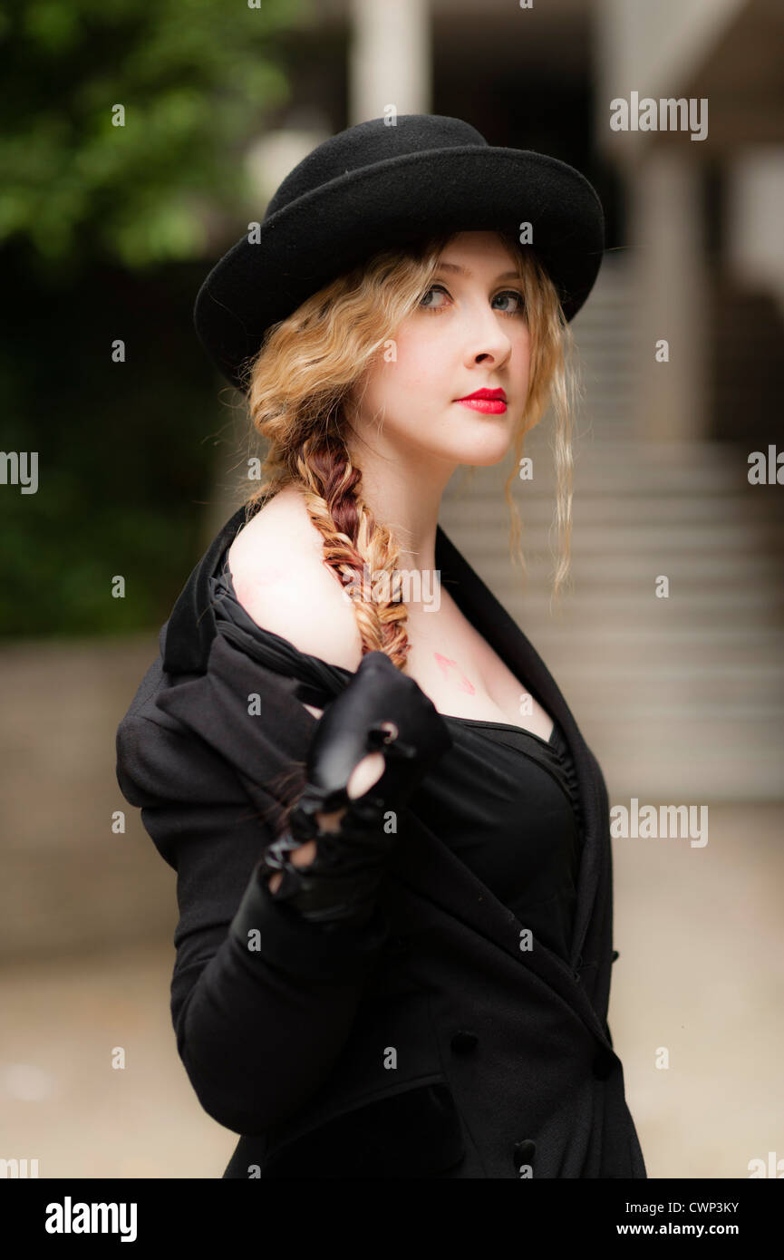 a young attractive woman with blonde hair and red lips wearing black in an Alt alternative fashion shoot, on location UK Stock Photo