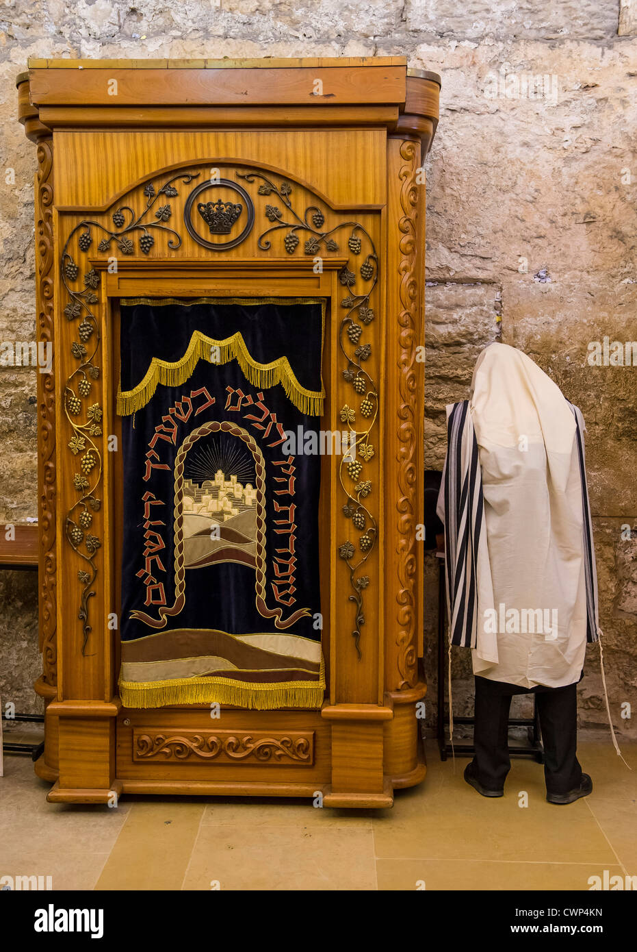 Jewish man prays in the Wailing wall during the Jewish holiday of Tisha B'av Stock Photo