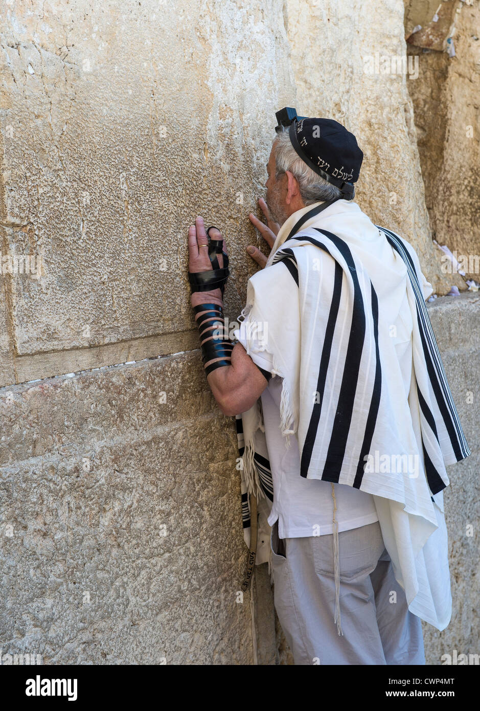 Jewish man prays in the Wailing wall during the Jewish holiday of Tisha B'av Stock Photo