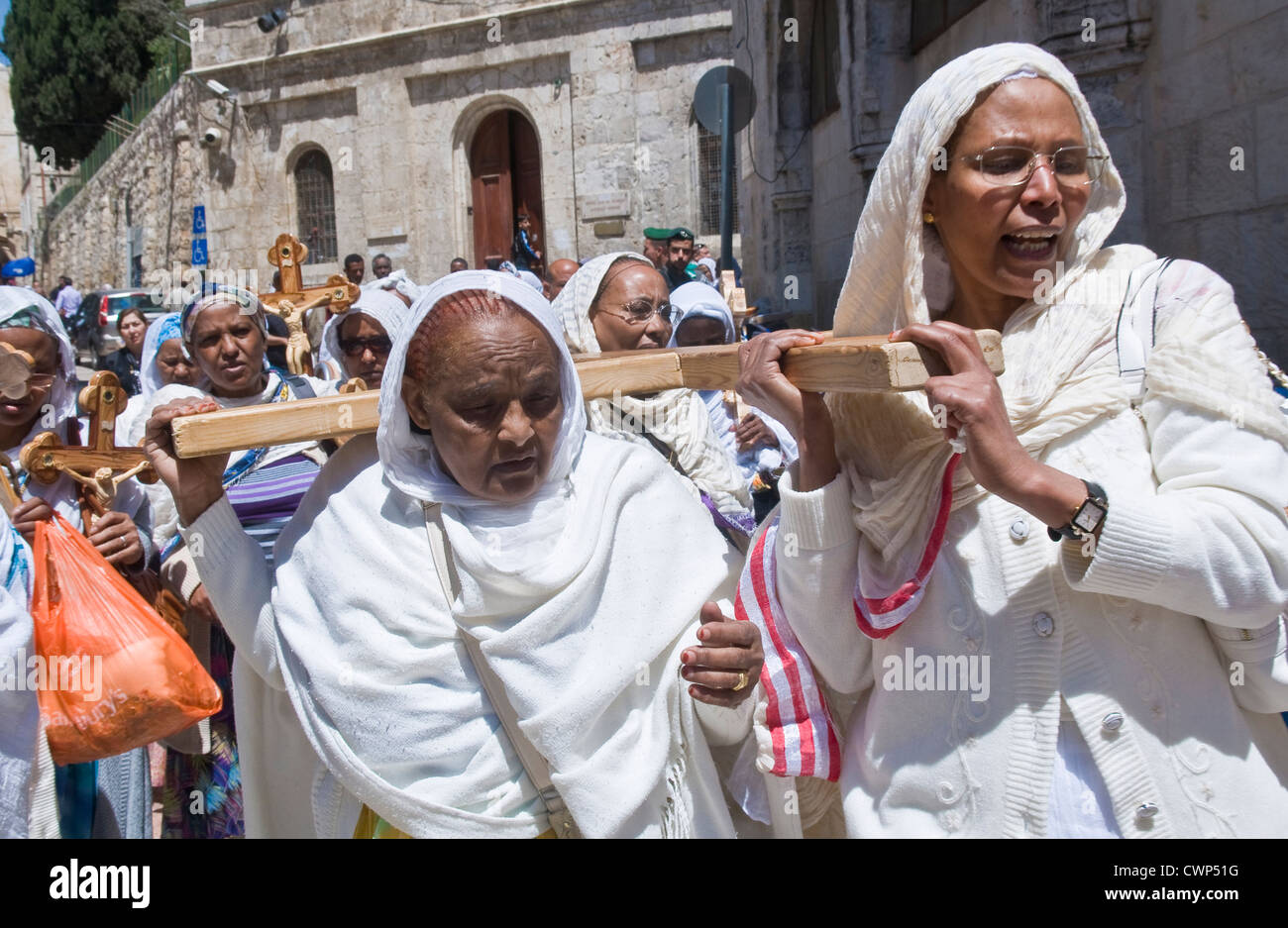 Ethiopian Christian pilgrims carry across along the Via Dolorosa in ...